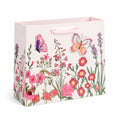 Sacchetto regalo 18 x 10 x 23 cm in carta rosa con manici a nastro - motivo floreale e farfalle